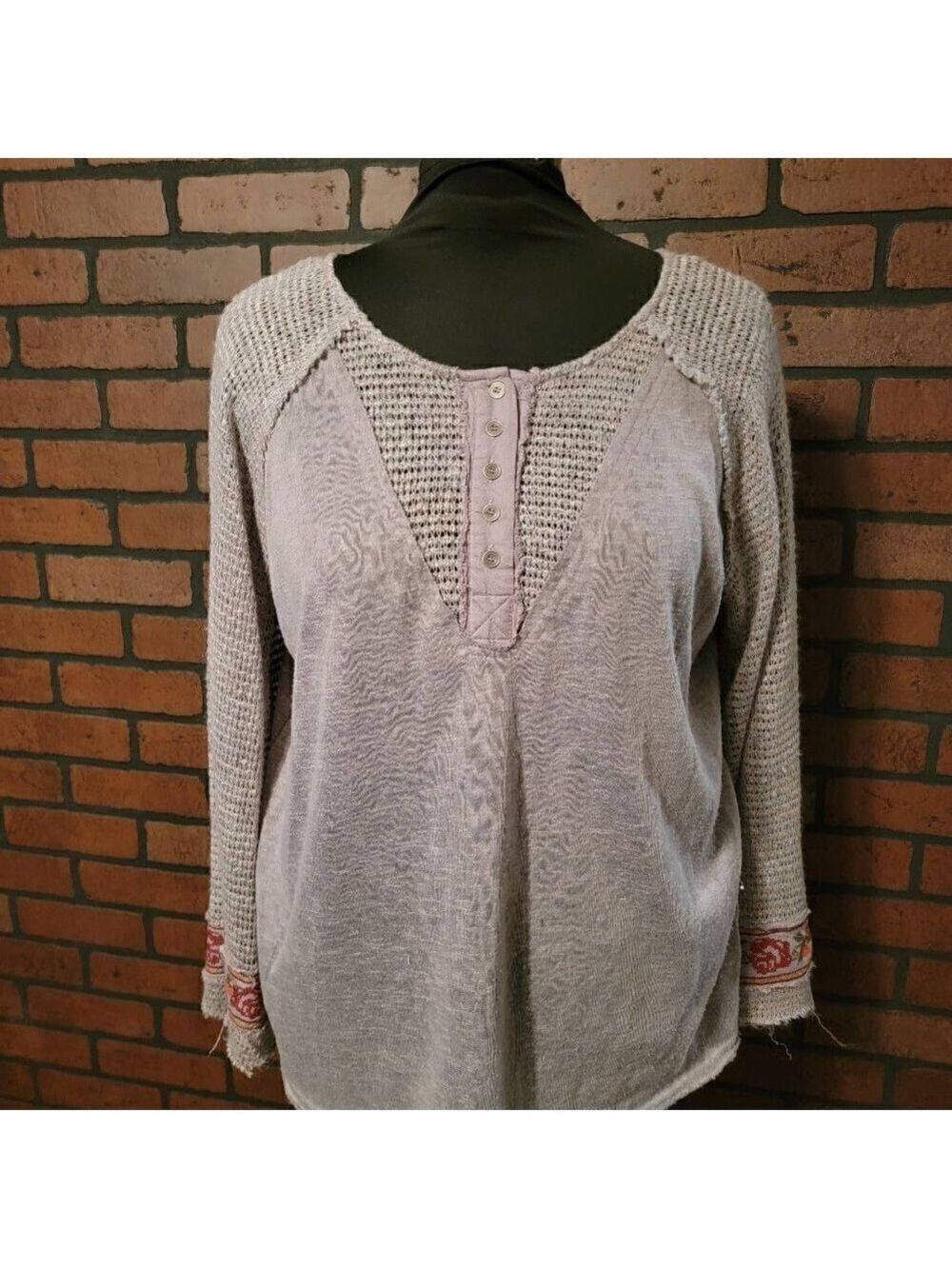Umgee mixed material bell sleeve top with embroidered flowers.